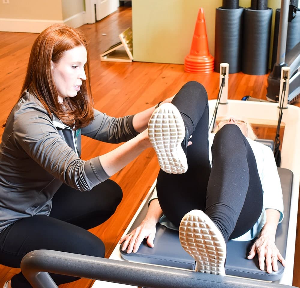 A GFPT clinician guiding a patient through movement assessment